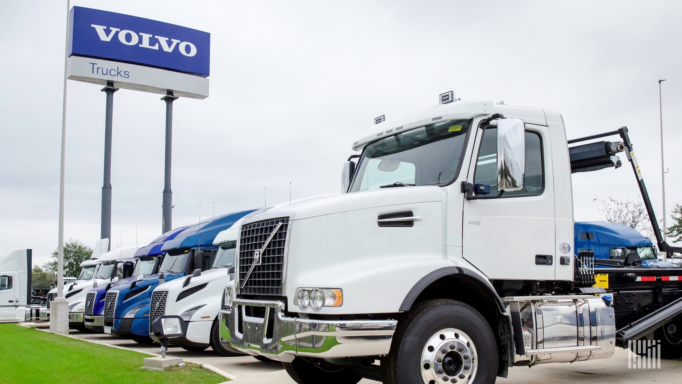 Whiute Volvo Class 8 truck and signage