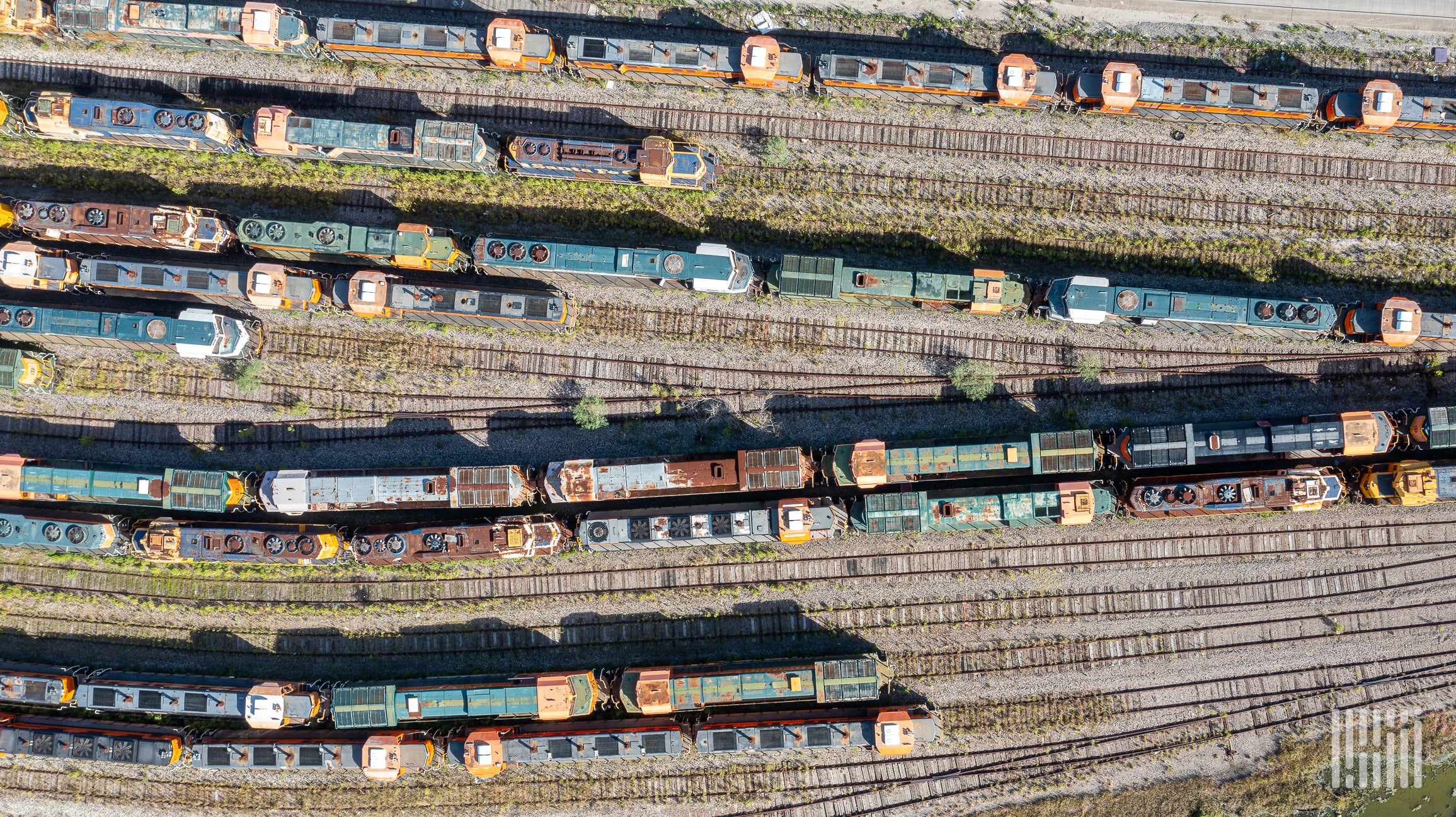 An aerial photograph of locomotives parked in a rail yard.