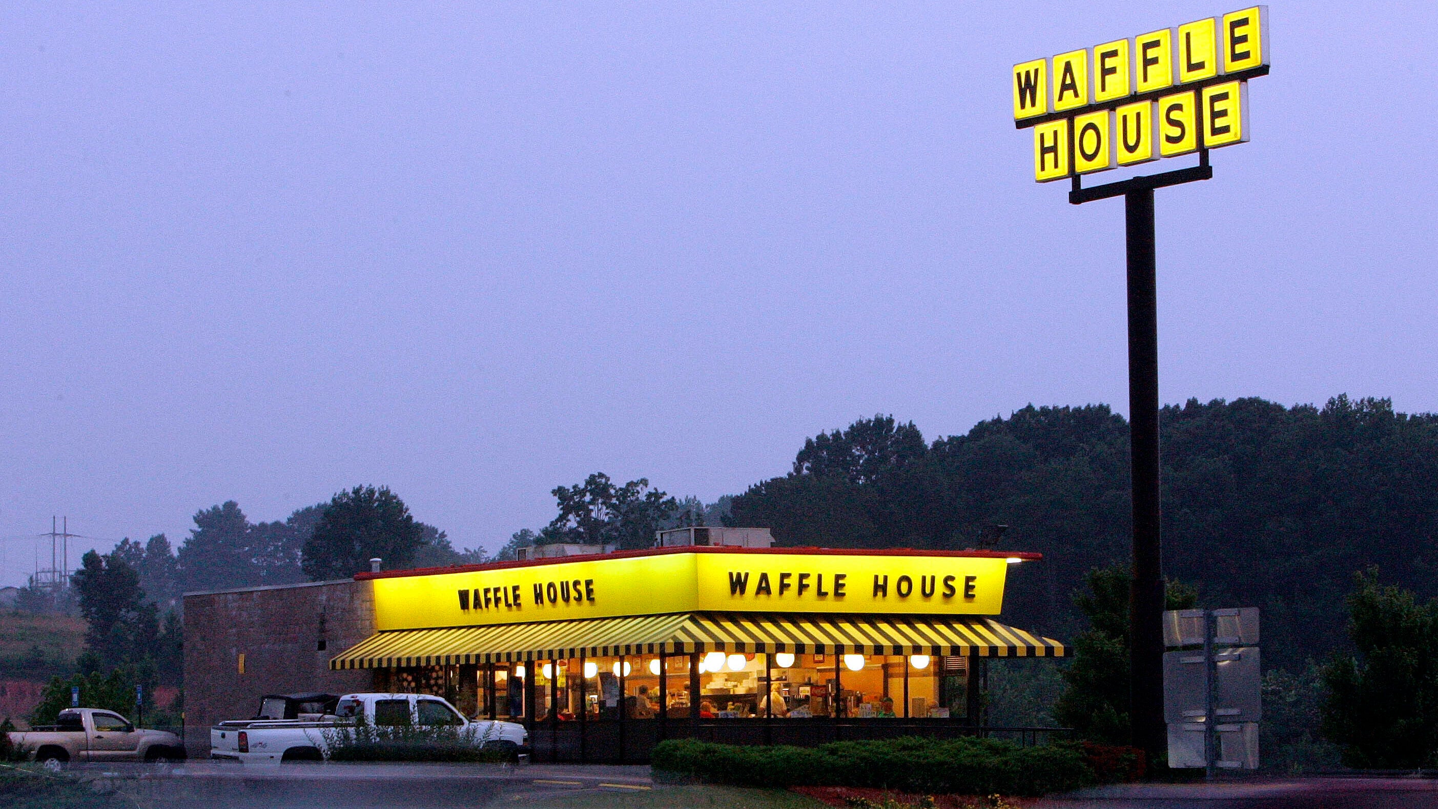 traffic flashes by breakfast diners at a Waffle House near Dawsonville, Ga.