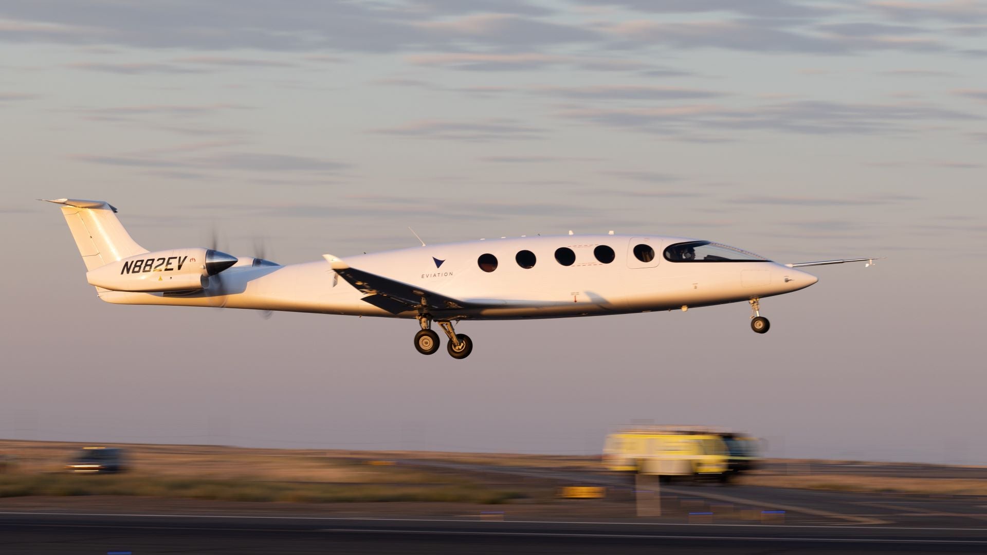 A small white passenger aircraft powered by batteries takes to the air.