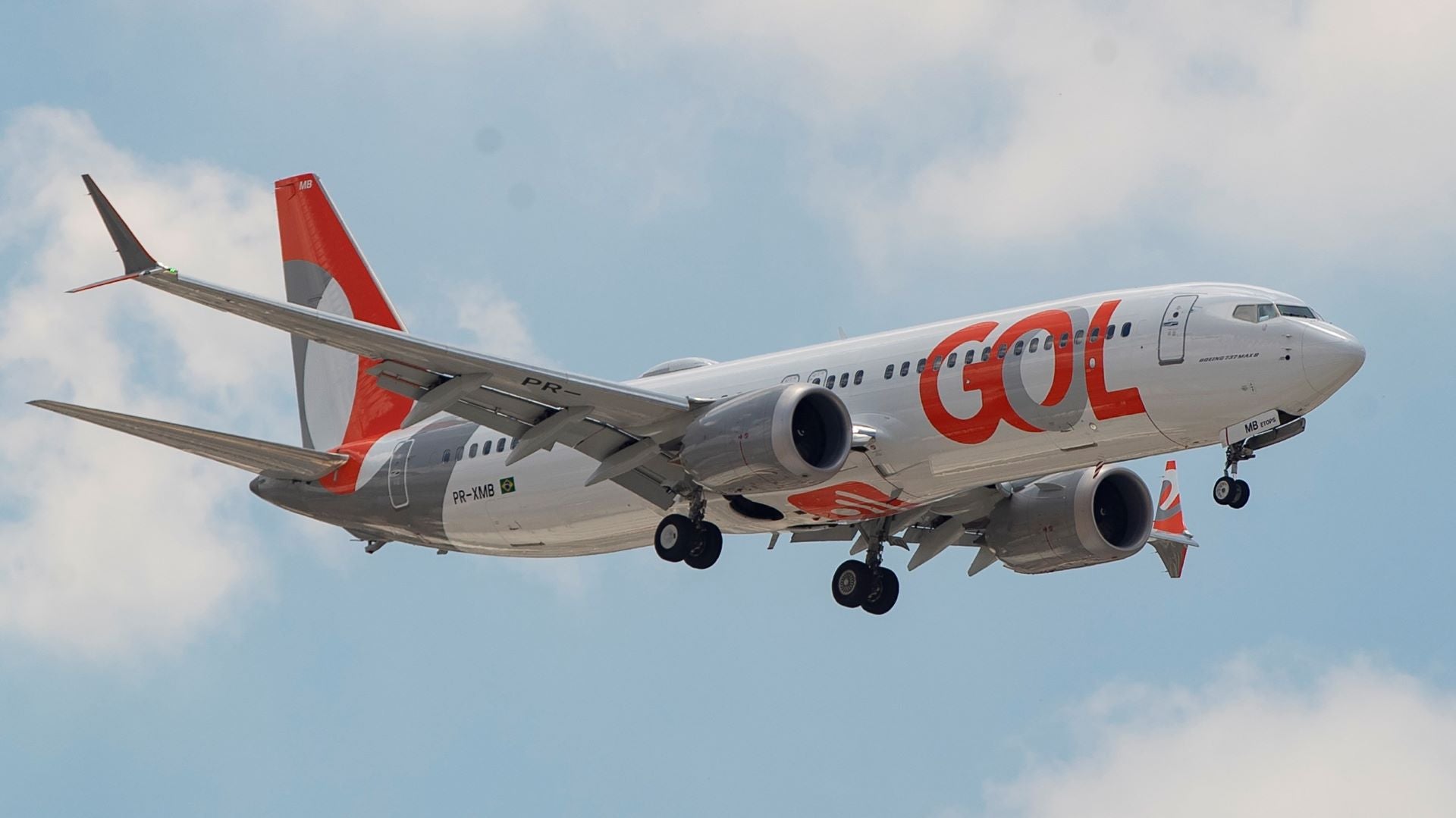 A GOL jetliner comes in for landing with wheels down.