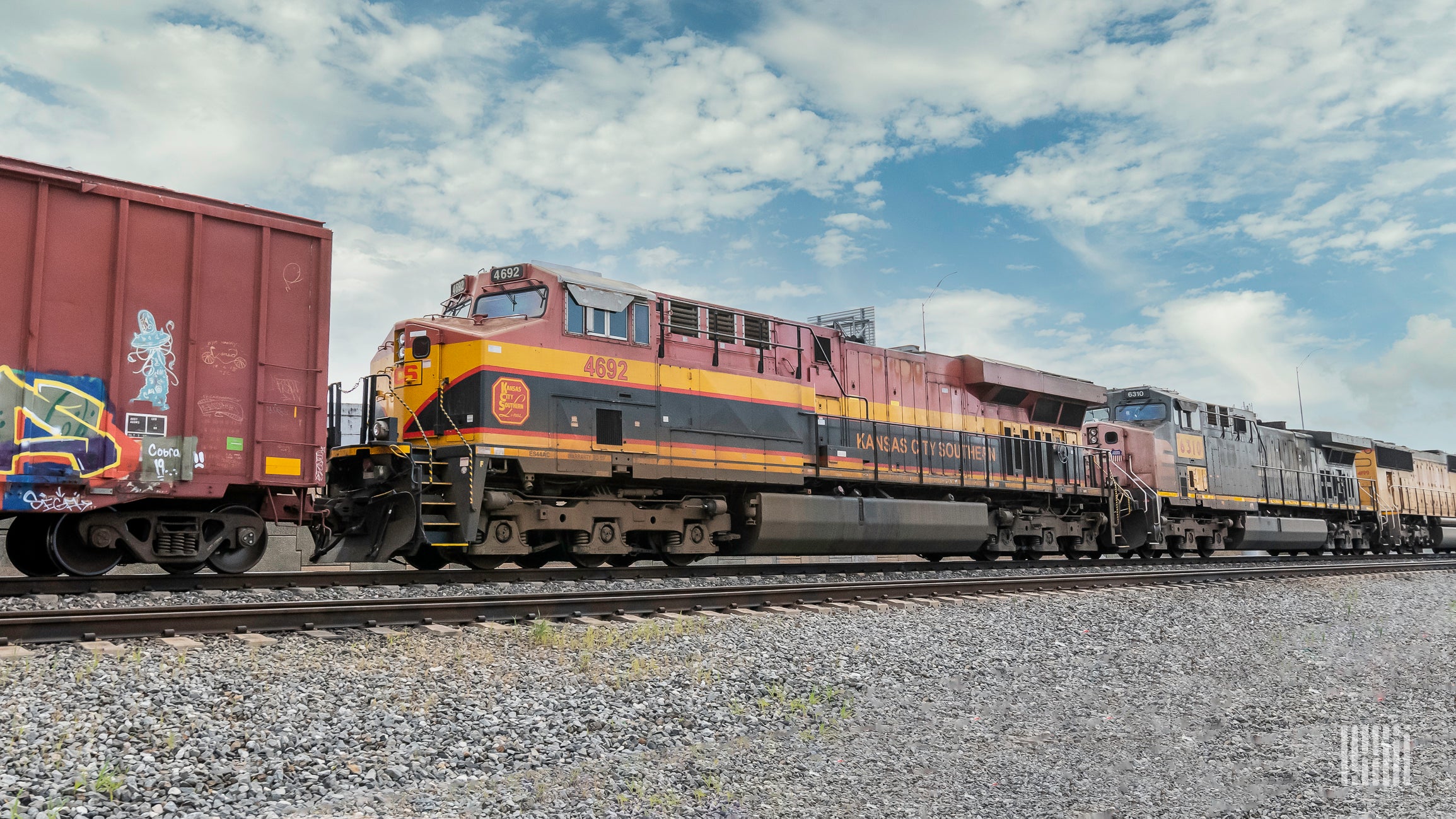 A Kansas City Southern locomotive sits on railroad track.