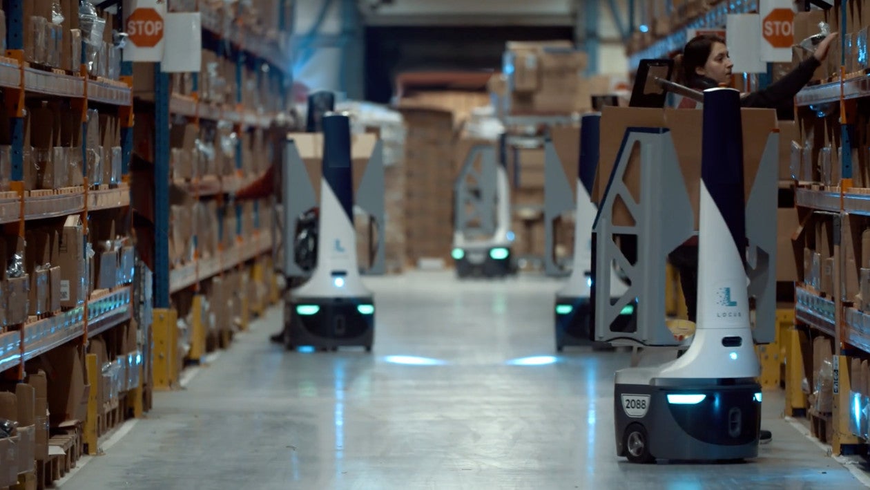 Robots moving around warehouse floor