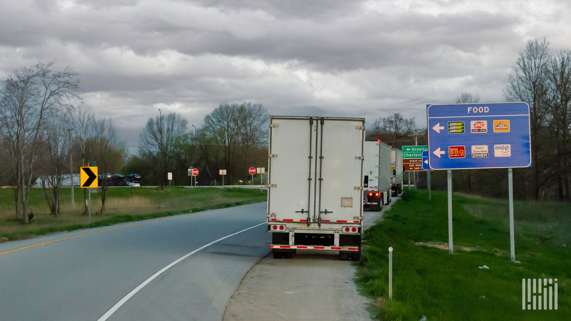 Trucks parked along exit ramp.