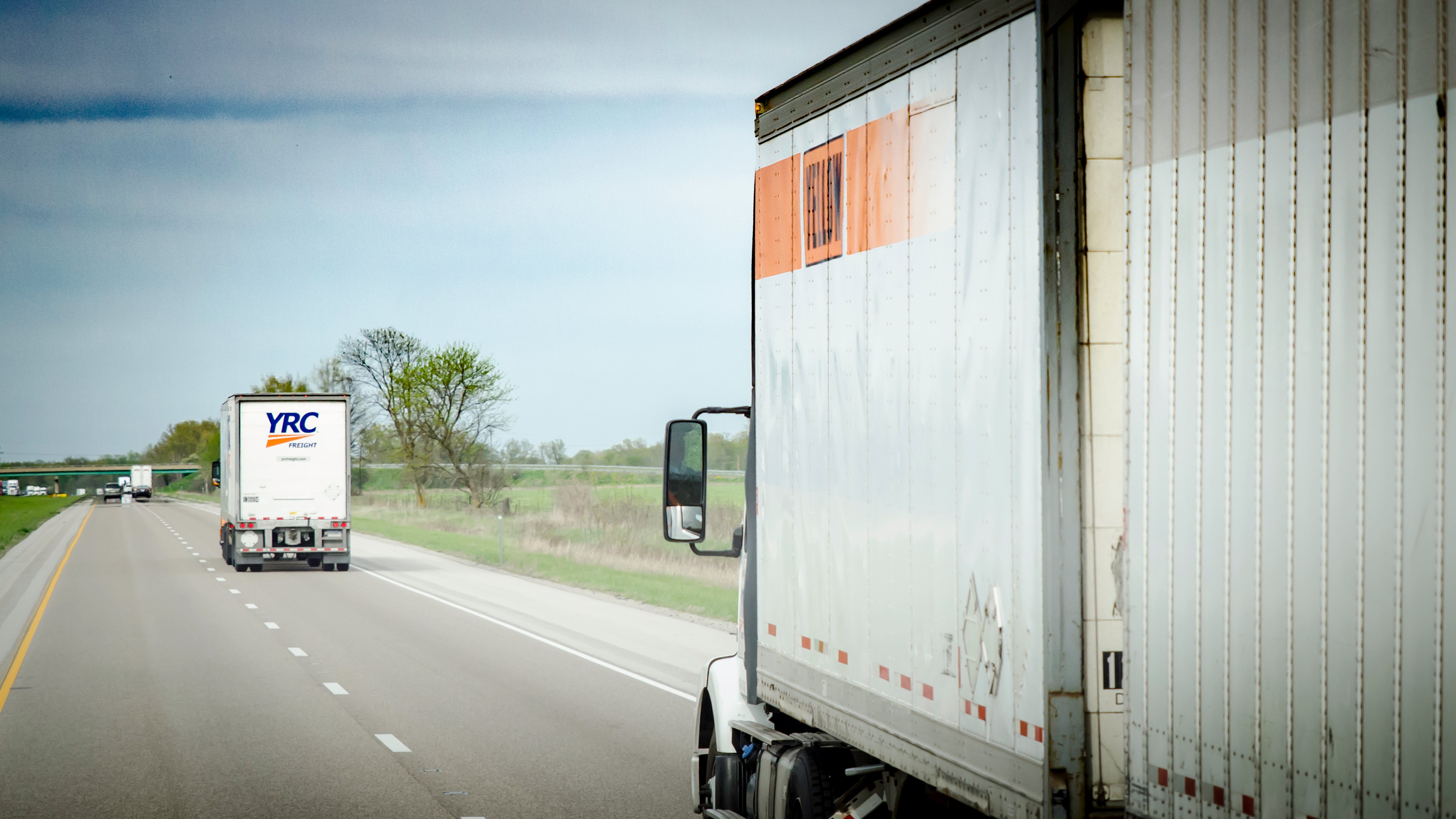 Two YRC trucks on the highway