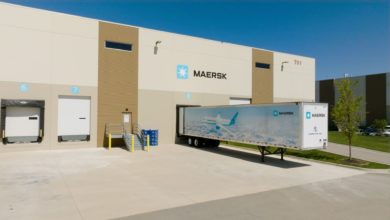 A Maersk Air Cargo truck trailer at a warehouse loading dock.