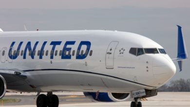 Close up of a white plane with blue United lettering.