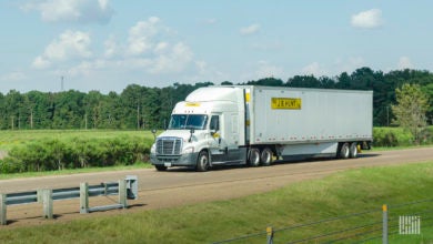 A white J.B. Hunt tractor-trailer on the highway