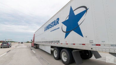 A Landstar trailer being pulled by a carrier on the highway