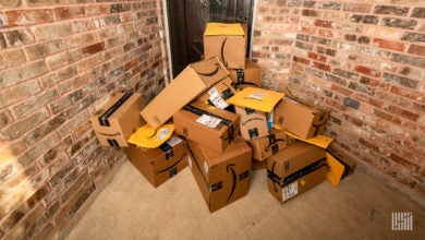 Amazon packages stacked at front door of house