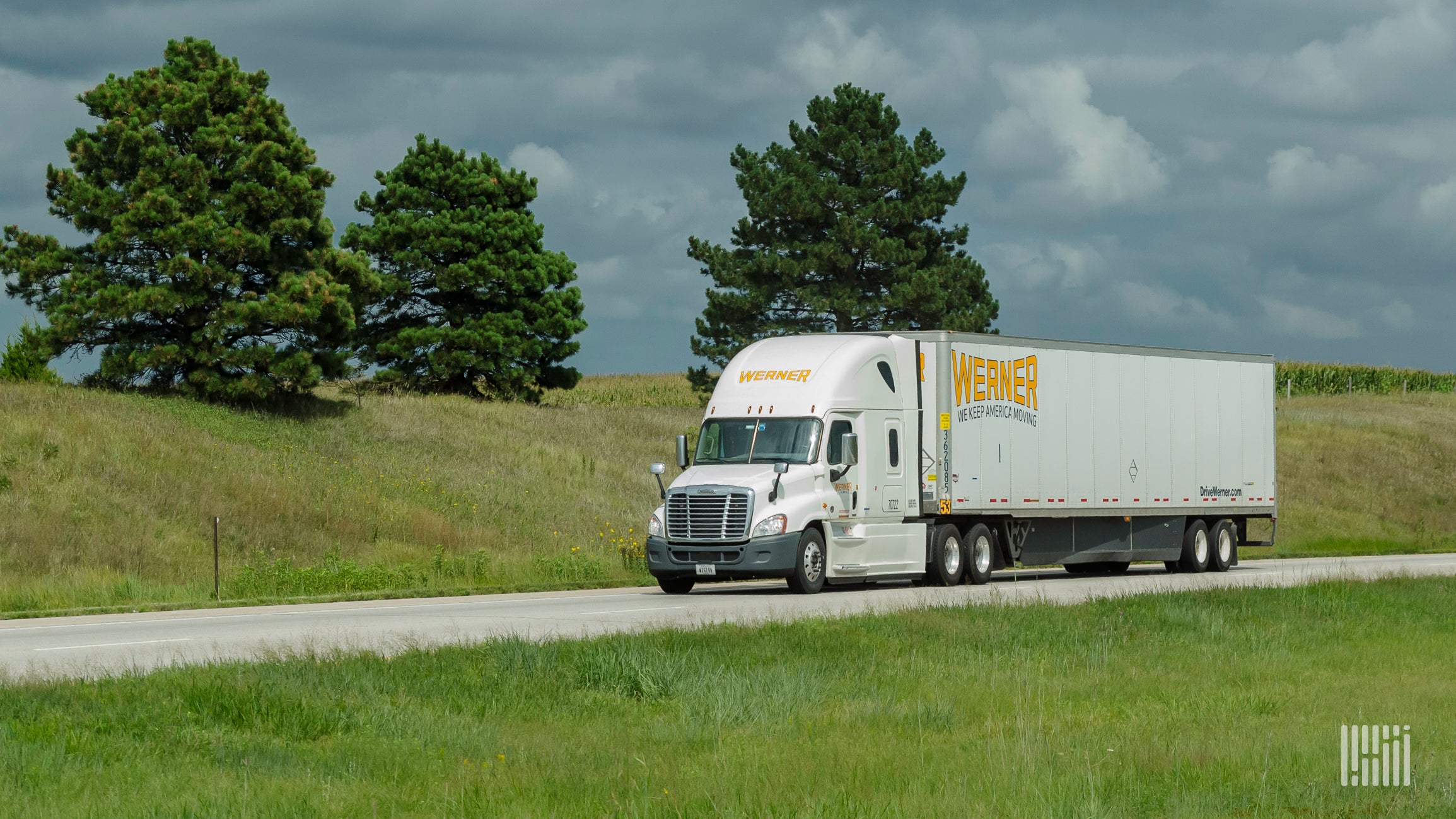 A white Werner tractor-trailer on the highway