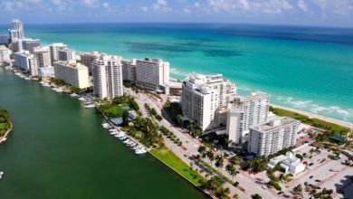 Aerial shot of Miami Beach hotels and surf.