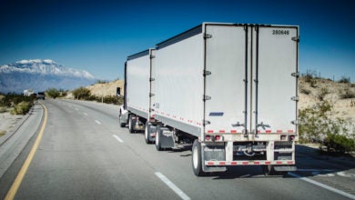 Truck hauling double trailer on highway