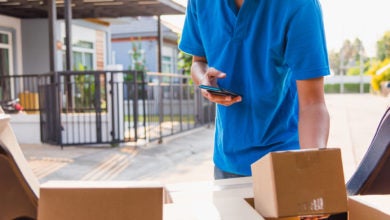 Delivery driver scans boxes