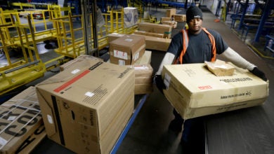 Package handler moves boxes inside FedEx facility