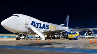 An Atlas Air cargo jet at night parked at the airport.