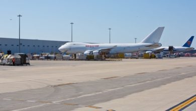 Cargo terminal at an airport with large freighters parked. on sunny day.