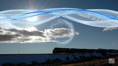 A train drives on the horizon. A computerized image of a cloud is above the train.