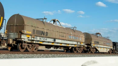 Two Norfolk Southern tank cars sit on rail track.