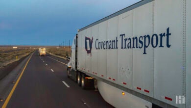 A rearview of a Covenant tractor-trailer on the highway.