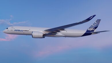 A large jet with Airbus A350F logo flies in blue sky.