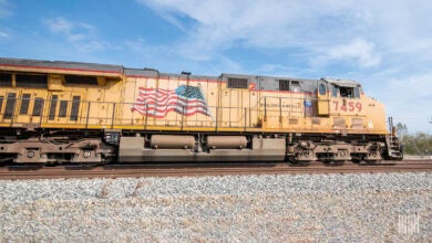 A Union Pacific locomotive travels down railroad track.