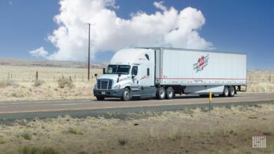 A white Heartland Express tractor-trailer on the highway