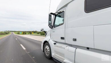 A white sleeper cab on the highway