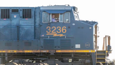 A man drives a train locomotive.