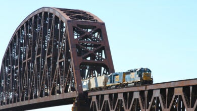 A CSX train crosses an old bridge.