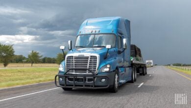 Blue Freightliner Cascadia on highway