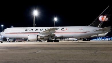 Night scene with a Cargojet plane on the ramp under the lights.