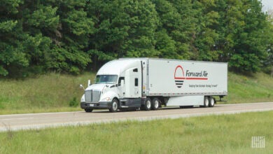 A white Forward Air trailer being pulled by a white tractor