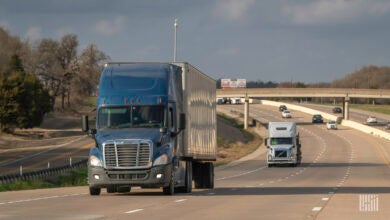 A blue tractor-trailer on a highway