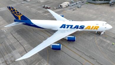 Overhead view of an Atlas Air jumbo jet, with blue tail, gold lettering.