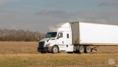 A white tractor-trailer on highway