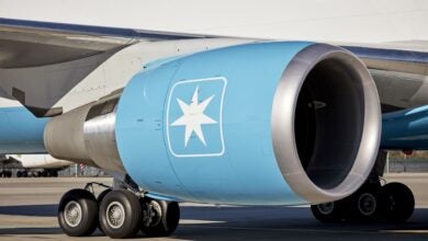 A close of an aircraft engine, painted light blue with a white star inside a box as the carrier's logo.