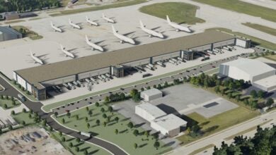 An artists image of the proposed air cargo center at Milwaukee airport, with aircraft lined up in front of a rectangular building.