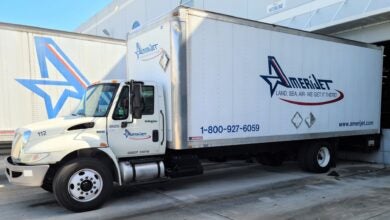 A white box van with blue Amerijet lettering at a loading dock.