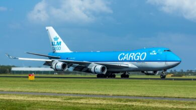 A light-blue KLM Cargo jumbo jet on the runway on a sunny day.