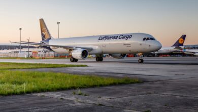 A white-and-blue Lufthansa Cargo jet on the tarmac at dawn.