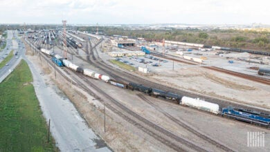 A train leaves a rail yard.