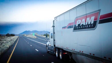 A white Pam Transportation tractor-trailer on the highway