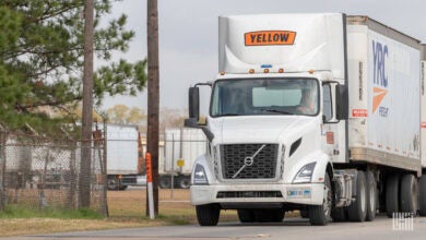 A Yellow tractor pulling two YRC trailers near the Houston terminal