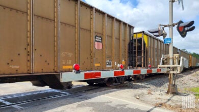 A train passes by a railroad crossing.