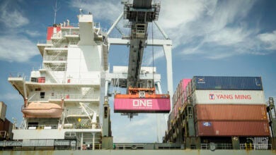 a photo of a dockworker crane operation on the West Coast