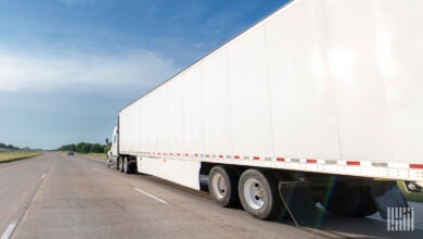 A white tractor-trailer on the highway