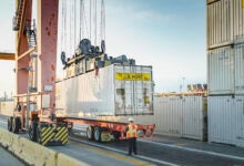 J.B. Hunt intermodal containers being lifted at a port