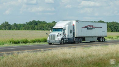 A white Pam tractor-trailer on the highway