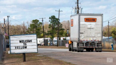 A Yellow tractor with one LTL trailer at a terminal